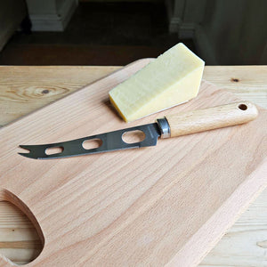Beech wood handled cheese knife on a wooden cheese board