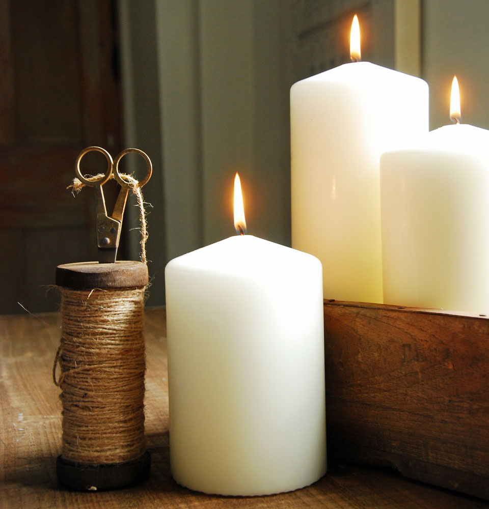 Selection of lit church pillar candles