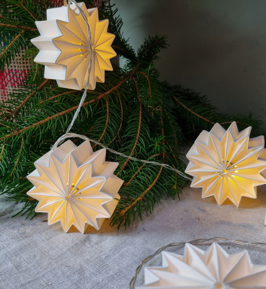 Handmade paper Christmas lights, each one lit with a warm white long lasting LED light