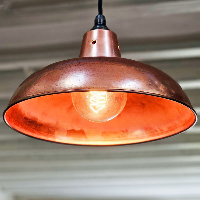 Polished copper pendant light lit