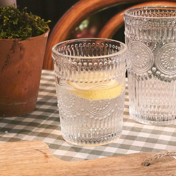Amore glass tumbler on a table.