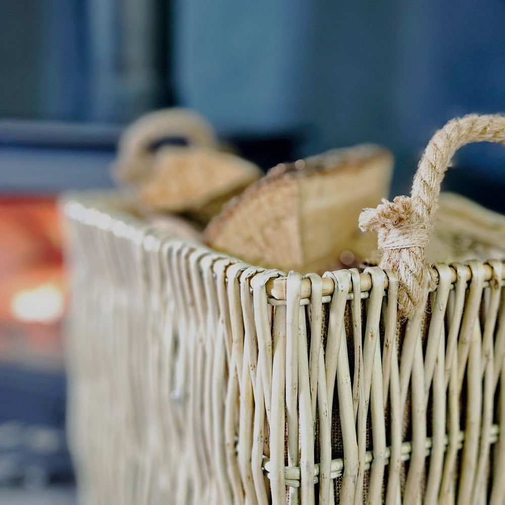 Close up of Belper log basket wicker basket weave and rope handles.