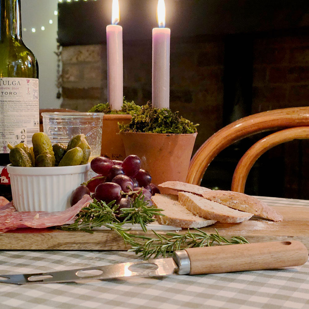 Antipasti on a long wooden charcuterie board at Christmas.