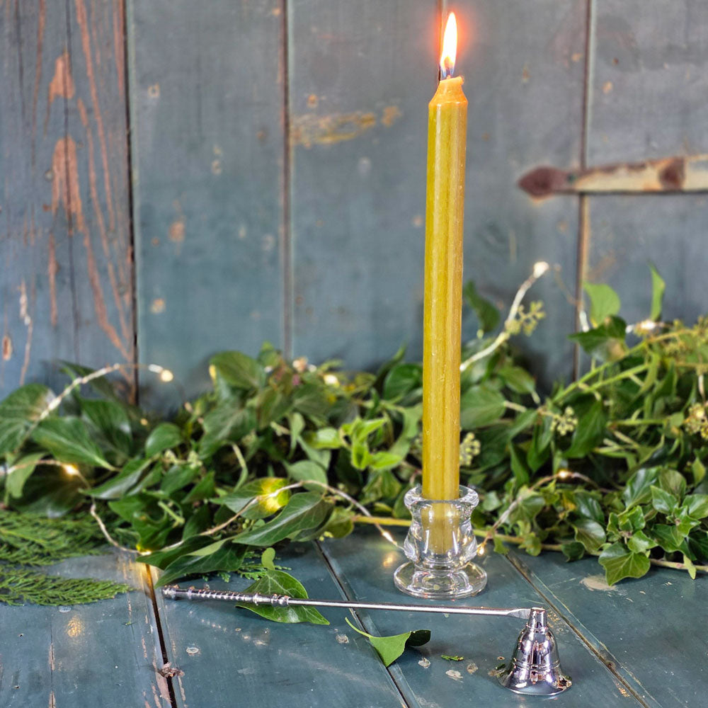 Glass dinner candle and candle snuffer