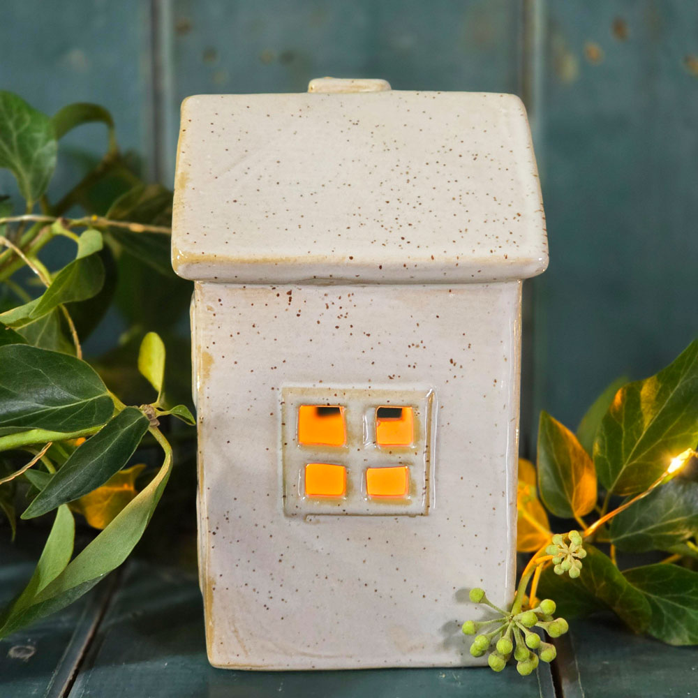 Side view of ceramic house tea light holder.