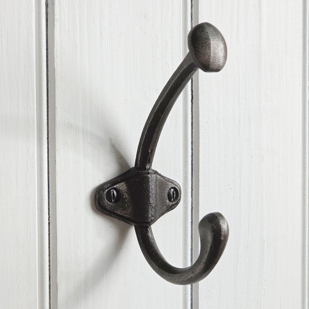 Black double hook on a white wooden background
