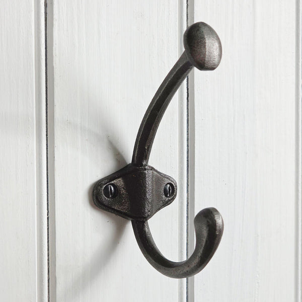 Black double hook on a white wooden background