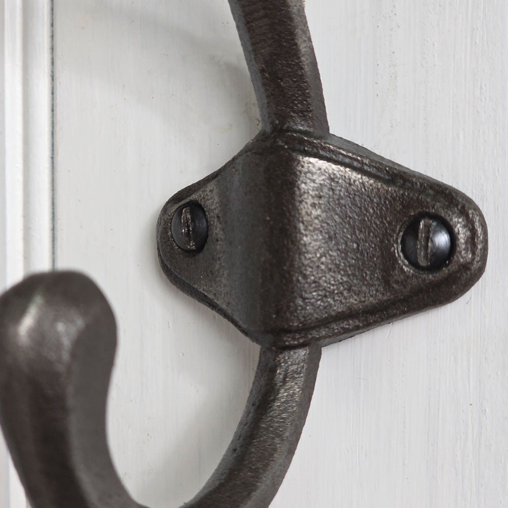 Close-up of a black metal door handle on a white door