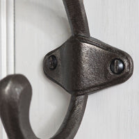 Close-up of a black metal door handle on a white door