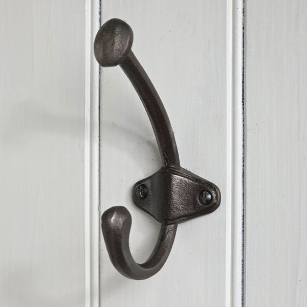 Black metal double hook on a white wooden panel