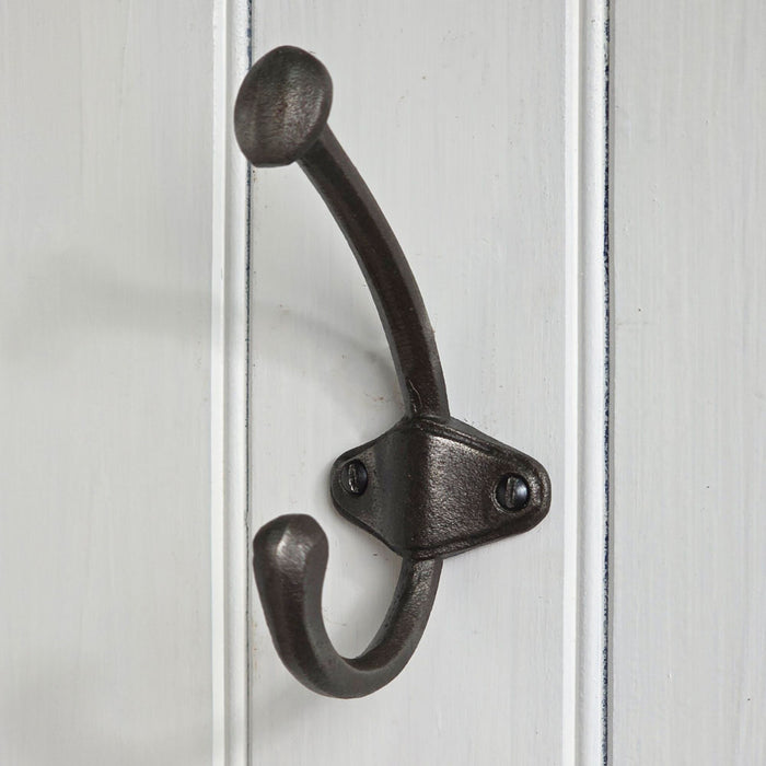 Black metal double hook on a white wooden panel