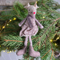 Single felt mouse Christmas tree decoration in a brown polka dot dress surrounded by Christmas tree foliage.