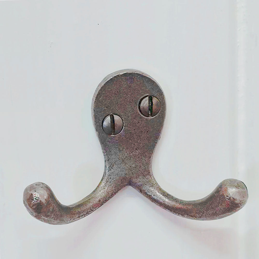 Cast iron double robe hook on a white background