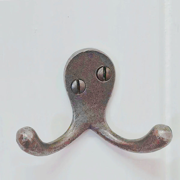 Cast iron double robe hook on a white background