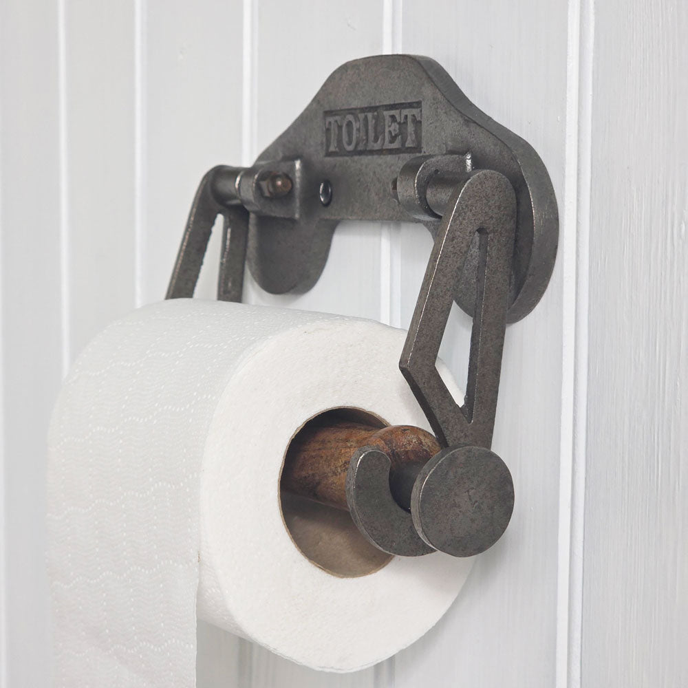 Metal toilet paper holder with 'TOILET' label on a white background