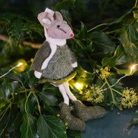 Felt mouse Christmas tree decoration in a green dress on green leaves with string lights