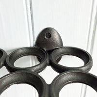 Close-up of a grey metal egg holder on a white background