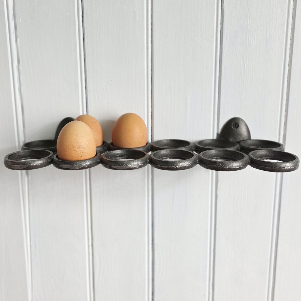 Egg holder with three eggs on a white wooden background
