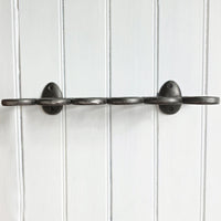 Metal egg rack  on a white paneled wall