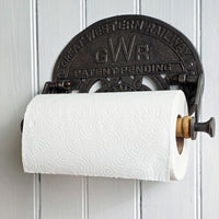 Vintage-style paper towel holder with 'GWR' branding on a white wall.