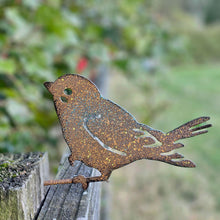 Wren Garden Art on a fence next to a hedge