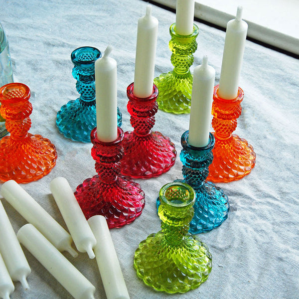 Jewel glass dandle holders on a table