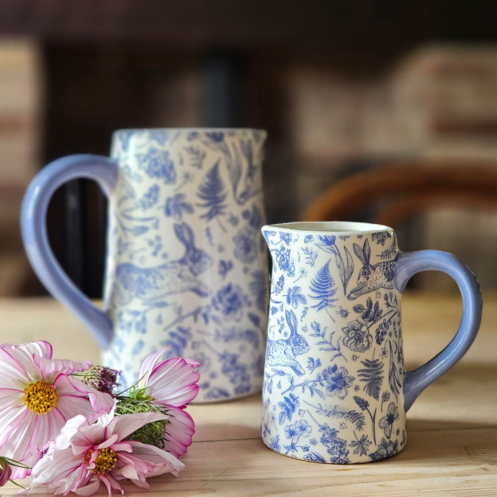 Blue hare print flower jugs on a kitchen table