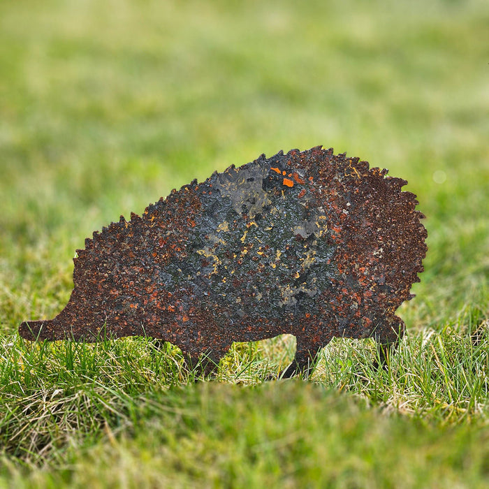 Hedgehog rusty metal garden art on a lawn.