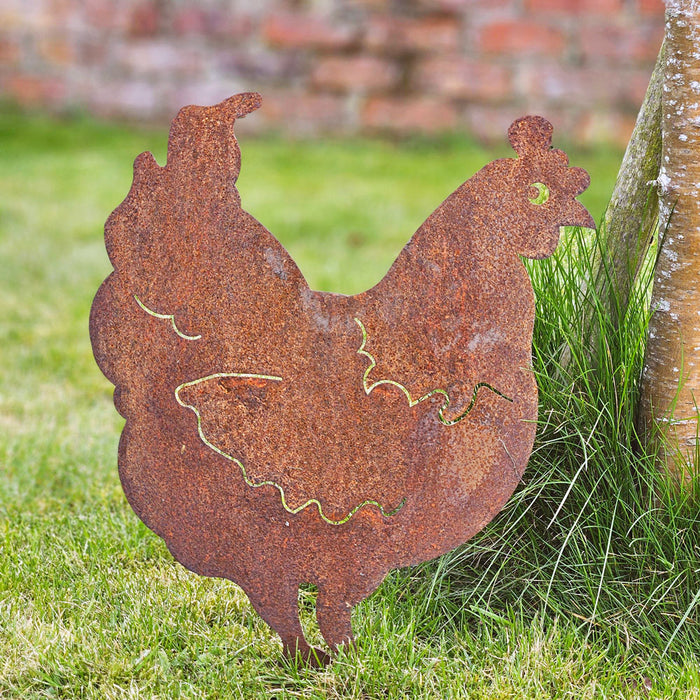 Rusty iron hen garden art on a lawn