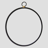 Black circular metal ring with a gold accent on a light gray background