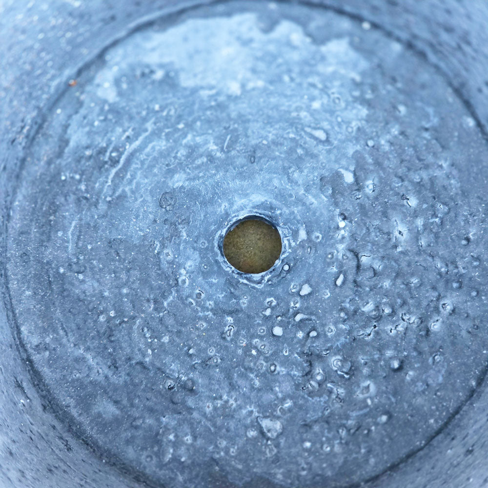 Drainage hole in terracotta pot.