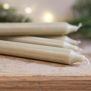 Khaki green Danish dinner candles on a table