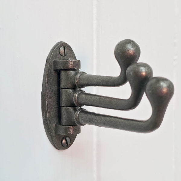 Vintage iron three-pronged hook on a white background