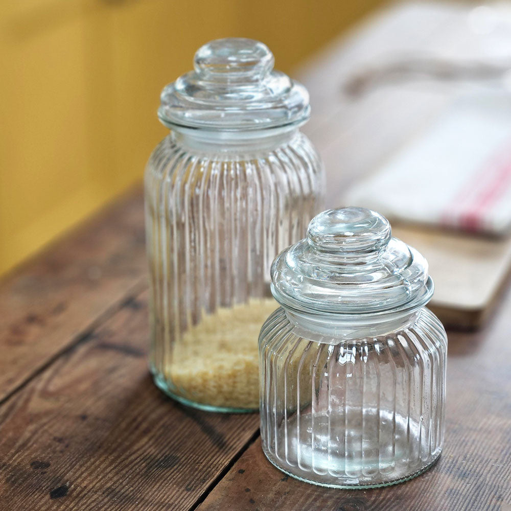 Two glass storage jars on a kitchen table