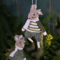 Felt mice Christmas tree decorations against foliage and tree lights.