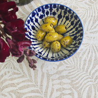 Olives in an Ikat bowl on top of Monstera oilcloth