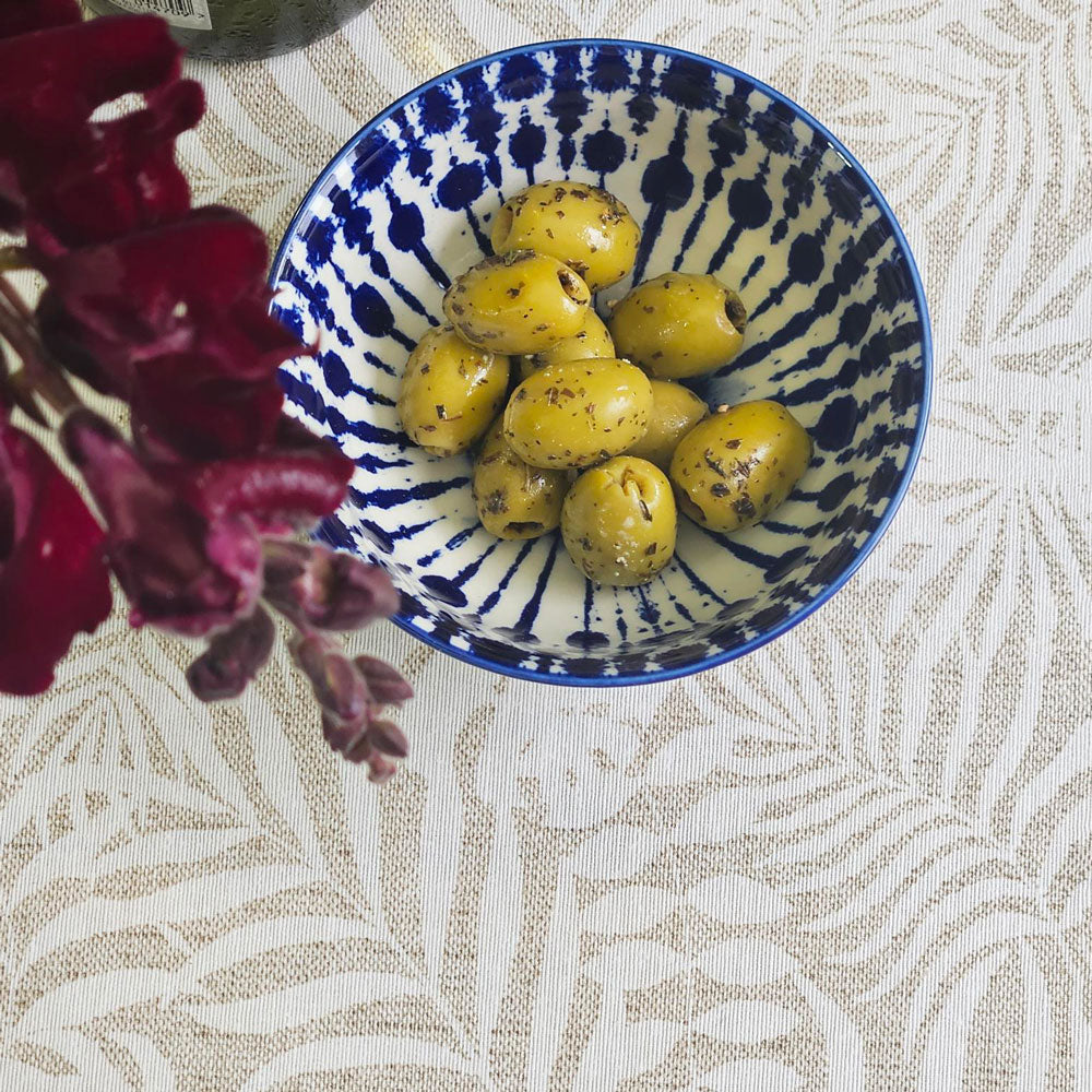 Olives in an Ikat bowl on top of Monstera oilcloth