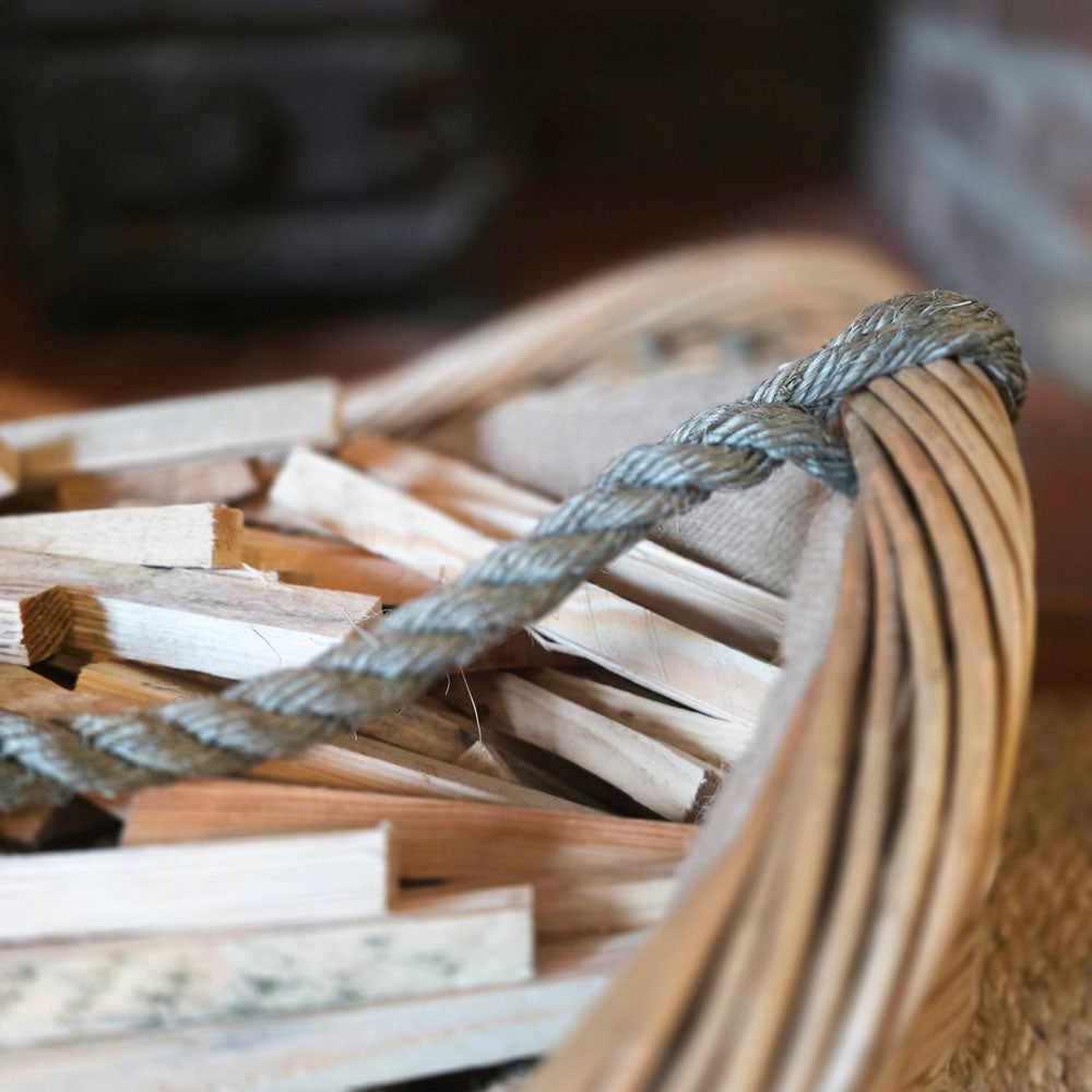 Close up of rope handle and lining on Oakham kindling basket.