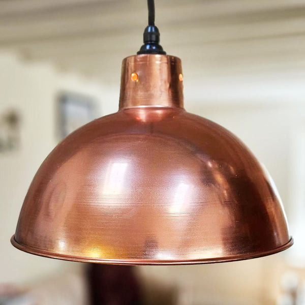 Polished copper 300 mm pendant light over kitchen island