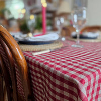 Red gingham wipe clean tablecloth on a Christmas table