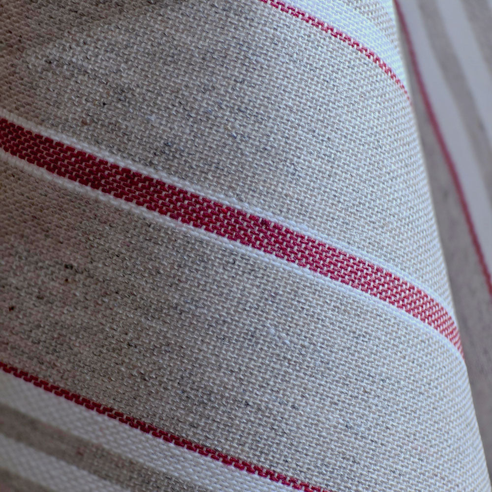 Close up of the soft drape of the red harbour stripe wipe clean tablecloth