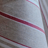Close up of the soft drape of the red harbour stripe wipe clean tablecloth
