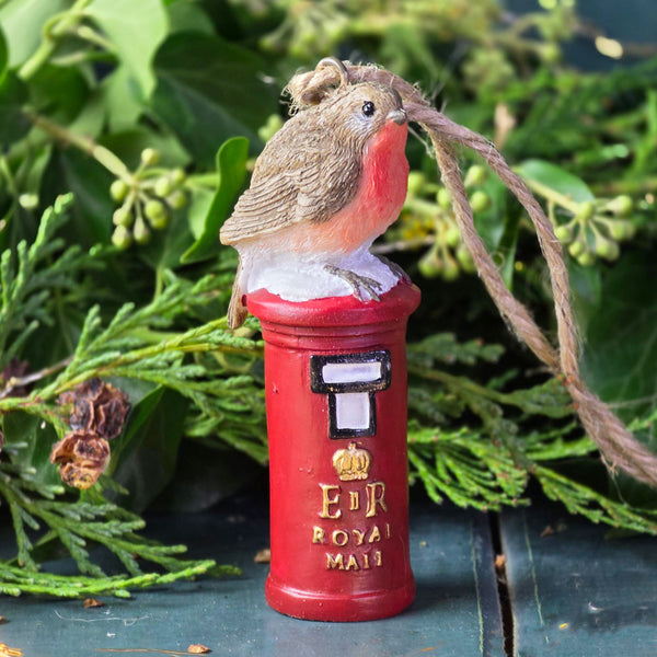 Robin Christmas tree decoration sat atop a postbox.
