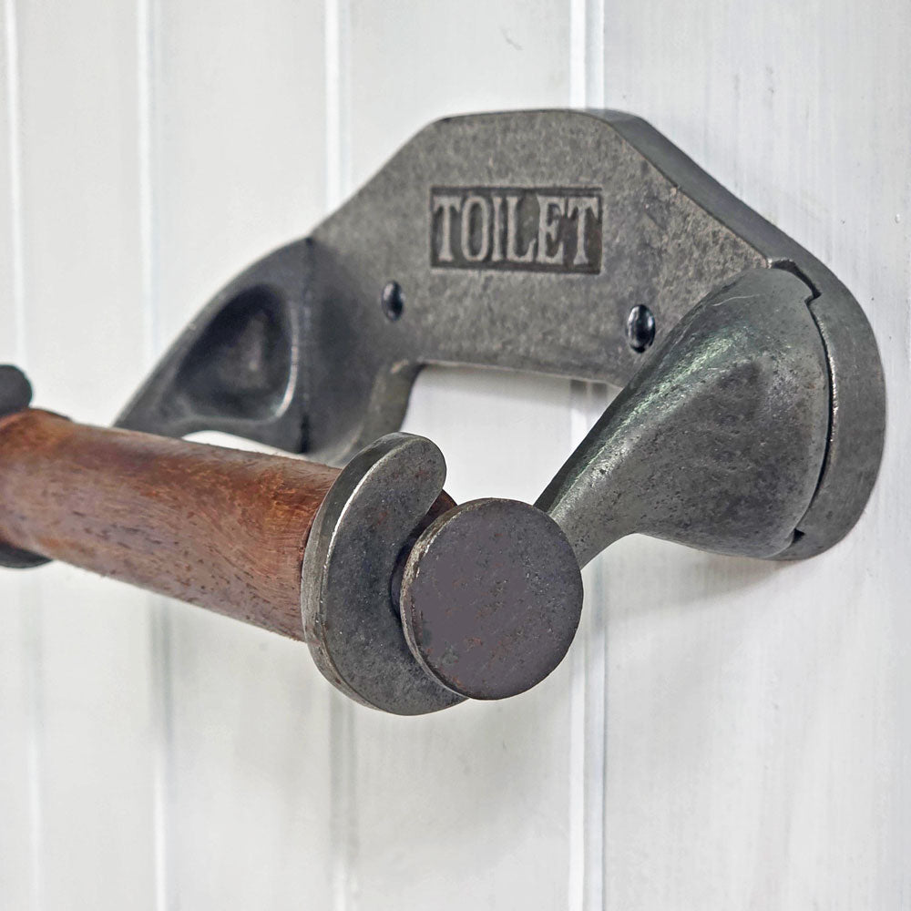 Metal toilet paper holder with wooden bar on a white background