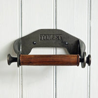 Vintage-style metal and wooden toilet paper holder on a white wooden panel background