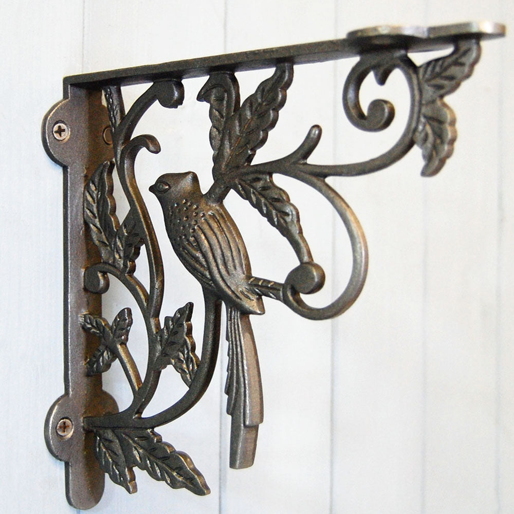 Cast iron shelf bracket with single bird decorative detailing.