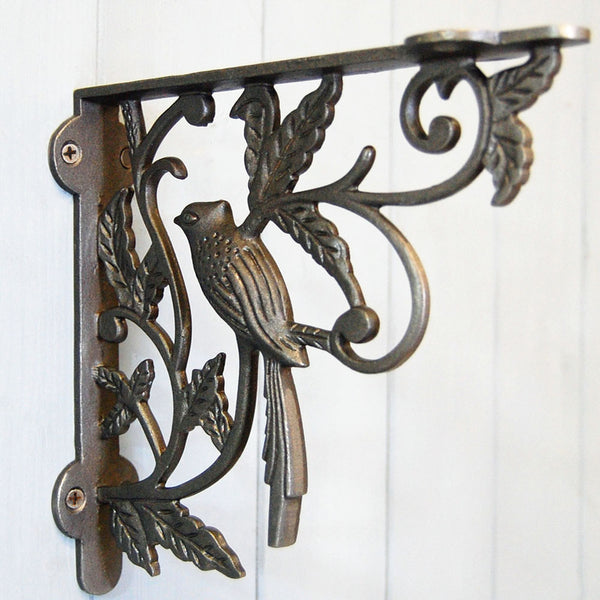 Cast iron shelf bracket with single bird decorative detailing.