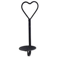 A black metal wall candle sconce with a heart-shaped top loop and a round candle base, shown against a plain white background.