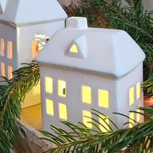 Close up of LED ceramic Christmas house decoration.