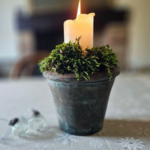 Christmas candle in aged flower pot